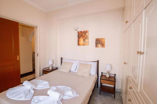 a bedroom with a bed with two night stands and two lamps at Oasis Zante Apartment in Zakynthos Town