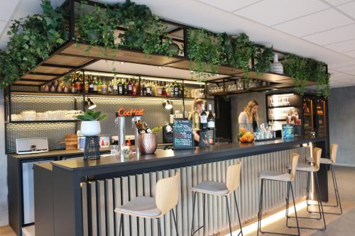 a bar with three stools at a counter at ibis Aubenas in Aubenas