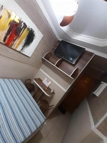 a room with a bed and a desk with a laptop on it at Hotel Luar in Sao Paulo