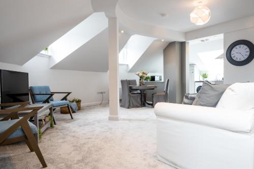 a living room with a white couch and a table at Bryan Street Apartments in Ballymena