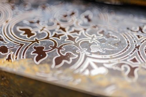 a close up of a metal plate with designs on it at Rynek 3 Old Town in Wrocław
