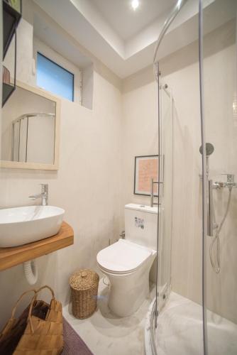 a bathroom with a toilet and a sink and a shower at Corfu Old Town Studio in Corfu