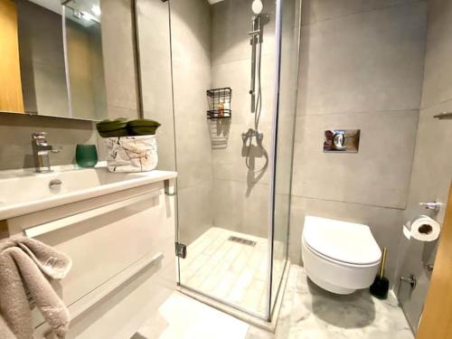 a bathroom with a shower and a toilet and a sink at Anfa Living 29-The Gatsby 5 Chic&New Apt near Sea in Casablanca