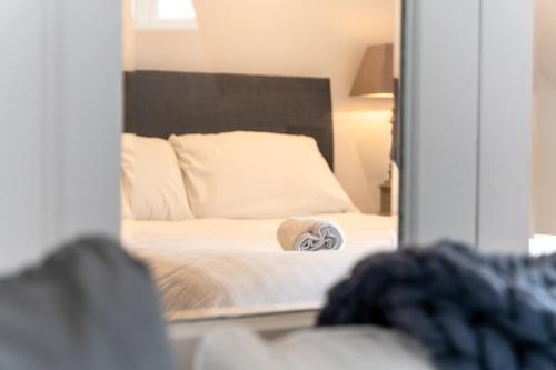 a reflection of a bed in a mirror at Bryan Street Apartments in Ballymena