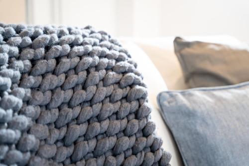a close up of a grey rug on a table at Bryan Street Apartments in Ballymena
