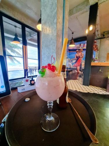 a drink with a straw on a table at Saphli Villa in Chumphon