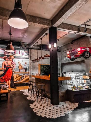a room with a bar and a car on the wall at Saphli Villa in Chumphon