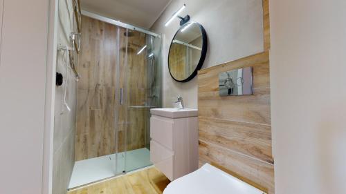 a bathroom with a shower and a toilet and a mirror at Przystanek Orle in Płaska