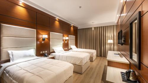 Кровать или кровати в номере فندق فلافور Flavor Hotel