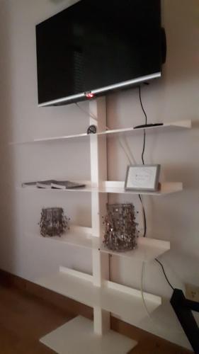 a shelf with a tv on top of a wall at Appartamento Diego in Milan