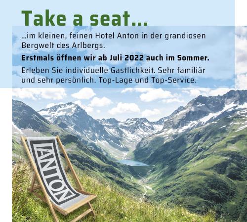 a sign sitting on top of a mountain at Quality Hosts Arlberg - Hotel ANTON in Sankt Anton am Arlberg