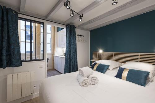 a bedroom with two beds with towels on them at DIFY Quatre Chapeaux - Centre ville in Lyon