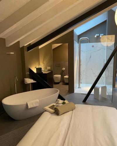 a bathroom with a large tub and a large window at DIMORA1934 Relax&Comfort in Tirano