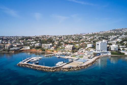 an aerial view of a marina with boats in the water at NLH Mati Seafront - Neighborhood Lifestyle Hotels in Mati