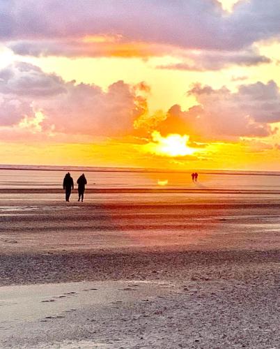 two people walking on the beach at sunset at Beach Sunset in Lytham St Annes