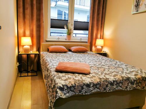 Posteľ alebo postele v izbe v ubytovaní Markowe Apartamenty Złoty Park