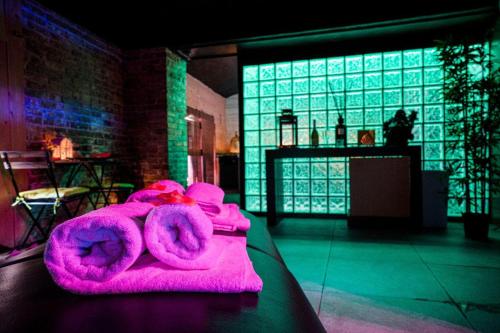 a pink teddy bear laying on a table in a room at Hotel Angioino & Spa in Naples