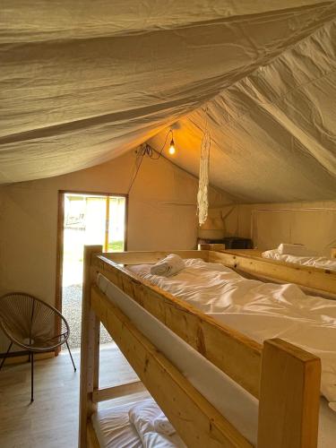 a bedroom with two beds in a tent at Green Fields - Durbuy in Durbuy