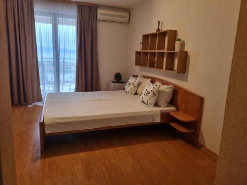 a bedroom with a bed and a large window at Guest House Suzana in Omišalj