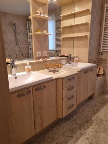 a bathroom with a sink and a mirror at Guest House Suzana in Omišalj