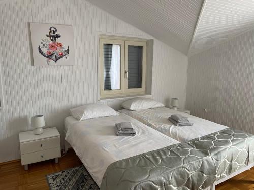 a bedroom with two beds and a window at B&B Sea Joy Rovinj in Rovinj