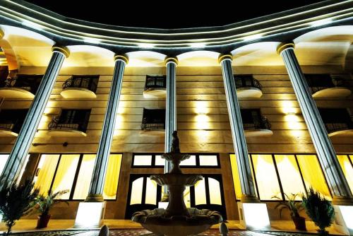 a building with balconies on the side of it at Grand Hotel Baroc in Zalău