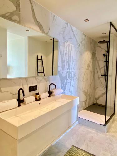 une salle de bain avec un lavabo et un miroir dans l'établissement LA SUITE - La Grande Motte P2 Avec Vue Panoramique, clim, WIFI, à La Grande Motte