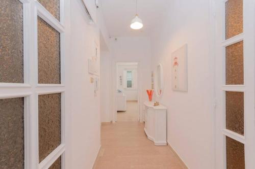 a hallway with white walls and a hallway with windows at Da zio Antonio in Vieste