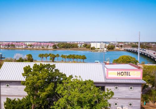 a hotel with a view of a river and a bridge at Hotel Folly with Marsh and Sunset Views in Folly Beach