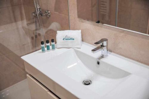 a bathroom sink with a towel on top of it at Casa dAmélia in Leiria