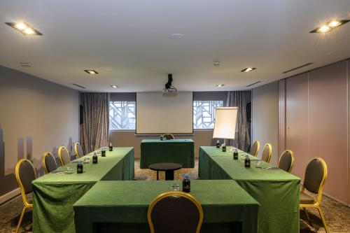 a meeting room with green tables and chairs at Idou Anfa Hôtel & Spa in Casablanca