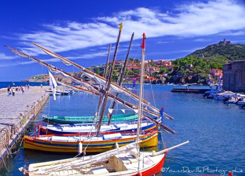 two boats are docked at a dock in the water at The Originals City, Hôtel Les Dômes, Perpignan Sud Saleilles in Perpignan