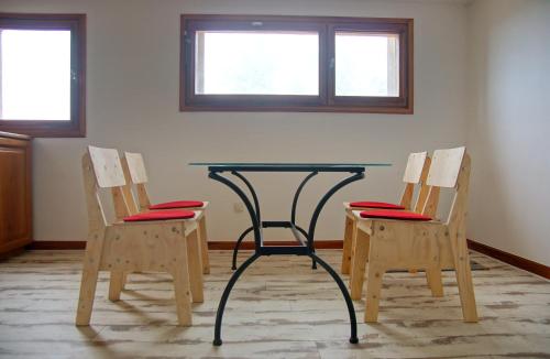a table and two chairs with a table and two windows at Mas Companyo - Vallespir - Céret - Grand Mas in Céret