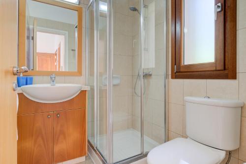 a bathroom with a shower and a toilet and a sink at 2 bedroom Villa Destu with private pool and golf views, Aphrodite Hills Resort in Kouklia