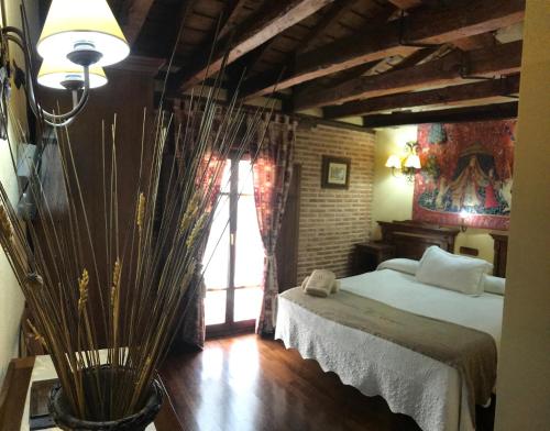 a bedroom with a large bed and a window at Hospederia Casa de Cisneros in Toledo