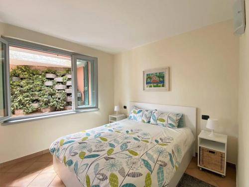 a bedroom with a bed and a window at San Sisinio Apartment Argegno in Argegno