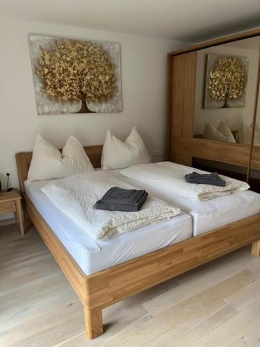 a bedroom with a large bed with white sheets at Christinenhof Top 5 mit großem Balkon in Lofer