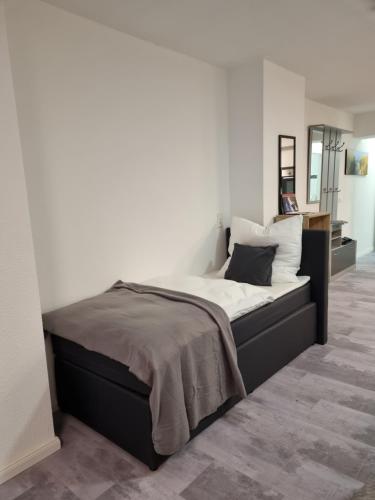 a bedroom with a large bed with white walls at SM2 Apartment in Triberg
