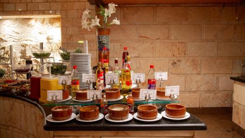 a table with a bunch of bottles and plates of food at Happy Life Village Dahab in Dahab