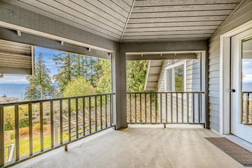 a screened in porch with a view of the ocean at Evergreen at Semiahmoo in Blaine