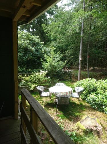 a patio with a table and chairs on a porch at Woudhof in Laag-Soeren