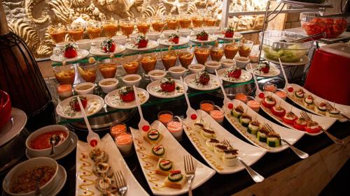a buffet with many plates of food on a table at Happy Life Village Dahab in Dahab
