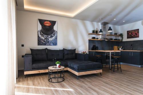a living room with a couch and a table at Nuovo Luxury Suite in Malia