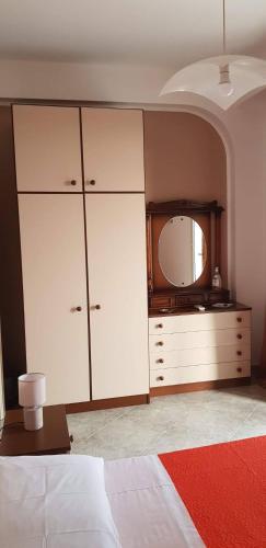 a bedroom with a dresser and a large mirror at Vacanze in Sicilia in Siculiana