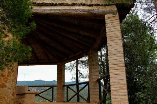 a brick building with a view of the mountains at Torre del Marqués Hotel Spa & Winery - Small Luxury Hotels in Monroyo