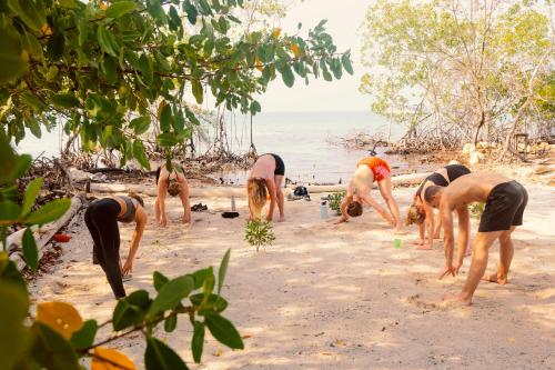 a group of men standing on a beach at Santa Lova Eco-hostel Isla Tintipan in Tintipan Island