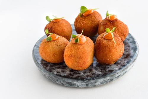 a plate with nine fruit on top at Torre del Marqués Hotel Spa & Winery - Small Luxury Hotels in Monroyo