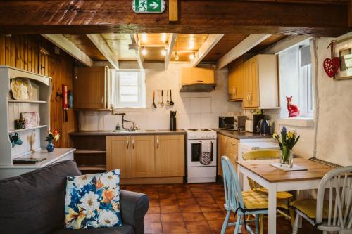a kitchen with a table and a dining room at Innish Beg Cottages in Blaney
