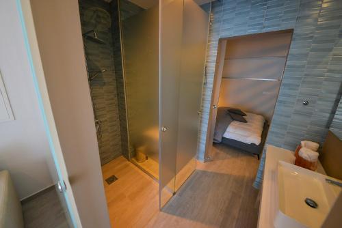a bathroom with a shower and a glass shower stall at De Lux Mythical SPA 9 in Paralimni