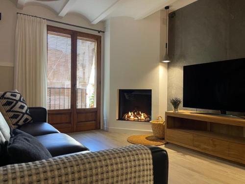 a living room with a couch and a fireplace at L' Alzina in Falset